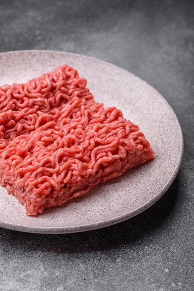 Raw ground beef for a burger or as an ingredient in a meat dish. Raw ground beef as a food background for your design