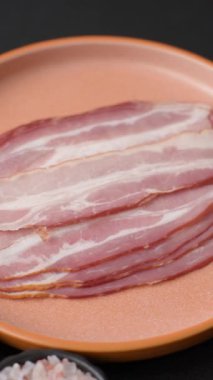 Meat, raw pork bacon sliced, organic food, protein for snacks. Raw bacon as a food background for your design