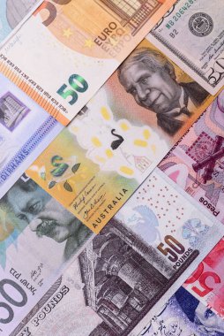 Paper money, banknotes of different countries in several denominations as a business background. Paper money and cash as a financial background for your design.