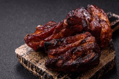 Grilled or barbecued pork ribs with sauce. Grilled ribs as a food background for your design.