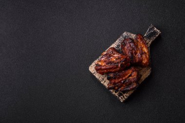 Grilled or barbecued pork ribs with sauce. Grilled ribs as a food background for your design.
