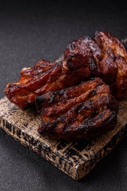 Grilled or barbecued pork ribs with sauce. Grilled ribs as a food background for your design.