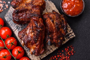 Grilled or barbecued pork ribs with sauce. Grilled ribs as a food background for your design.