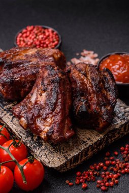 Grilled or barbecued pork ribs with sauce. Grilled ribs as a food background for your design.