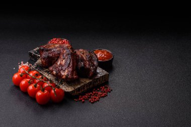 Grilled or barbecued pork ribs with sauce. Grilled ribs as a food background for your design.