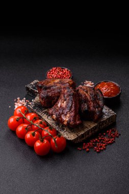 Grilled or barbecued pork ribs with sauce. Grilled ribs as a food background for your design.