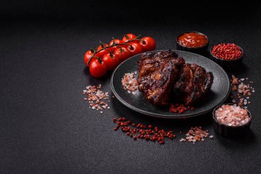 Grilled or barbecued pork ribs with sauce. Grilled ribs as a food background for your design.