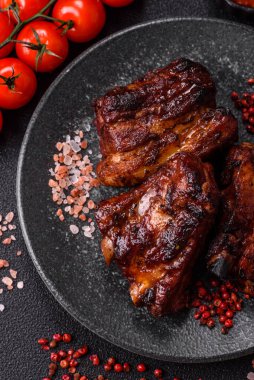 Grilled or barbecued pork ribs with sauce. Grilled ribs as a food background for your design.