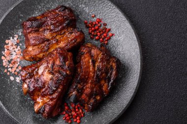 Grilled or barbecued pork ribs with sauce. Grilled ribs as a food background for your design.