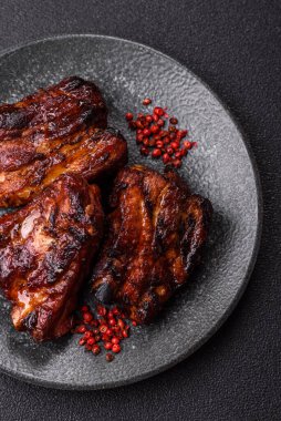 Grilled or barbecued pork ribs with sauce. Grilled ribs as a food background for your design.