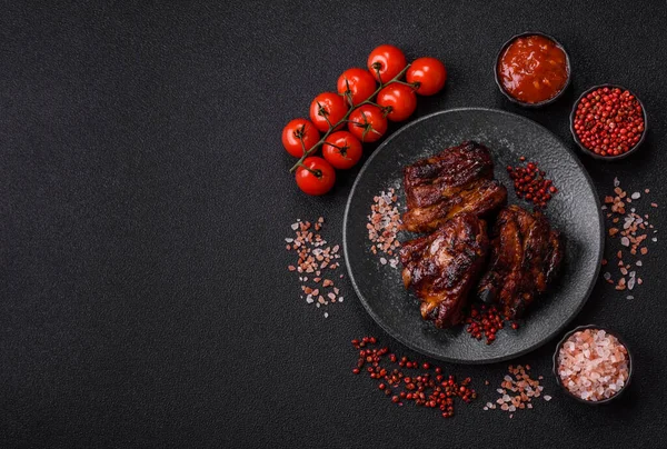 Grilled or barbecued pork ribs with sauce. Grilled ribs as a food background for your design.