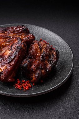 Grilled or barbecued pork ribs with sauce. Grilled ribs as a food background for your design.