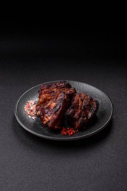 Grilled or barbecued pork ribs with sauce. Grilled ribs as a food background for your design.