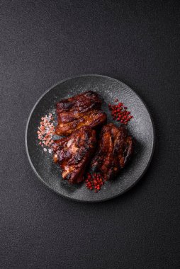 Grilled or barbecued pork ribs with sauce. Grilled ribs as a food background for your design.