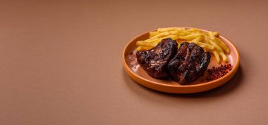Grilled or barbecued pork ribs with sauce. Grilled ribs as a food background for your design.