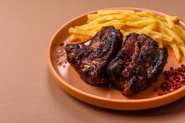 Grilled or barbecued pork ribs with sauce. Grilled ribs as a food background for your design.