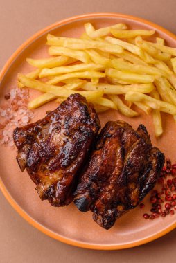 Grilled or barbecued pork ribs with sauce. Grilled ribs as a food background for your design.