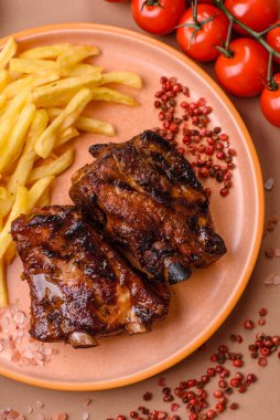 Grilled or barbecued pork ribs with sauce. Grilled ribs as a food background for your design.