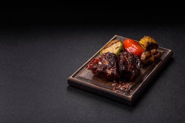 Grilled or barbecued pork ribs with sauce. Grilled ribs as a food background for your design.
