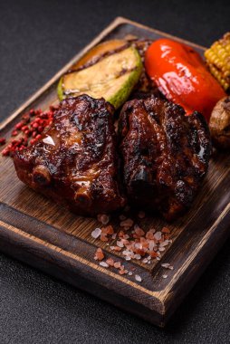 Grilled or barbecued pork ribs with sauce. Grilled ribs as a food background for your design.
