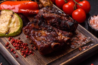 Grilled or barbecued pork ribs with sauce. Grilled ribs as a food background for your design.