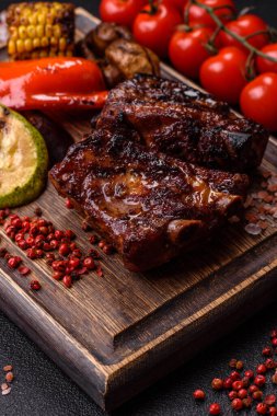 Grilled or barbecued pork ribs with sauce. Grilled ribs as a food background for your design.