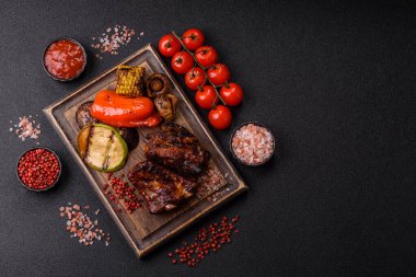 Grilled or barbecued pork ribs with sauce. Grilled ribs as a food background for your design.