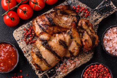 Chicken breast cooked on a grill or barbecue with sauce. Grilled chicken as a food backdrop for your design