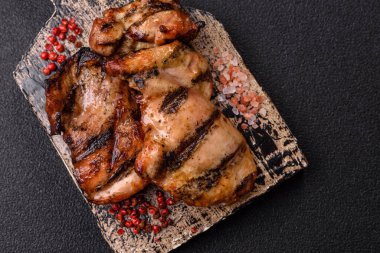 Chicken breast cooked on a grill or barbecue with sauce. Grilled chicken as a food backdrop for your design