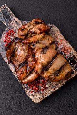 Chicken breast cooked on a grill or barbecue with sauce. Grilled chicken as a food backdrop for your design