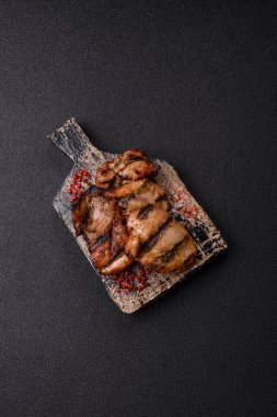 Chicken breast cooked on a grill or barbecue with sauce. Grilled chicken as a food backdrop for your design