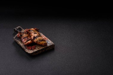 Chicken breast cooked on a grill or barbecue with sauce. Grilled chicken as a food backdrop for your design