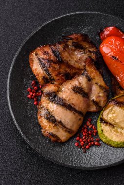 Chicken breast cooked on a grill or barbecue with sauce. Grilled chicken as a food backdrop for your design