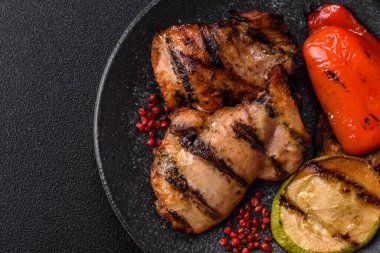 Chicken breast cooked on a grill or barbecue with sauce. Grilled chicken as a food backdrop for your design