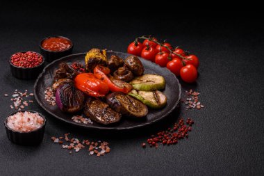 Izgara sebze, dolmalık biber, mantar ve kabak soslu sağlıklı vejetaryen yemeği. Tasarımın için yemek arkaplanı olarak bir tabakta ızgara sebze..