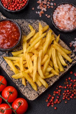 French fries cooked in oil with sauce, crispy golden chips, unhealthy food. French fries as a food background for your design