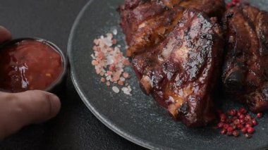 Grilled or barbecued pork ribs with sauce. Grilled ribs as a food background for your design.