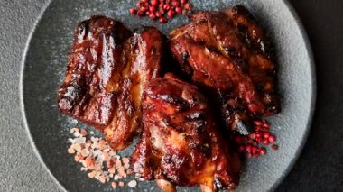 Grilled or barbecued pork ribs with sauce. Grilled ribs as a food background for your design.
