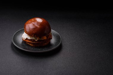 A burger, a hamburger with cheese, beef, and a bun, is unhealthy takeaway food. A burger or cheeseburger as a food background for your design.