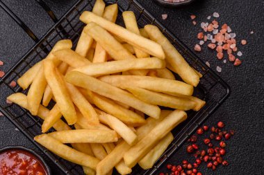 French fries are salty, crispy, and fried in oil, unhealthy takeaway food. French fries as a food backdrop for your design.