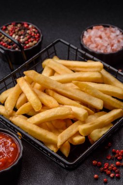 French fries are salty, crispy, and fried in oil, unhealthy takeaway food. French fries as a food backdrop for your design.
