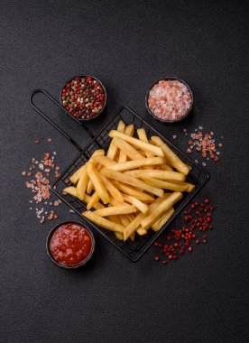 French fries are salty, crispy, and fried in oil, unhealthy takeaway food. French fries as a food backdrop for your design.