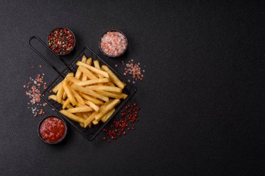 French fries are salty, crispy, and fried in oil, unhealthy takeaway food. French fries as a food backdrop for your design.