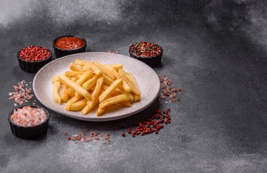 French fries are salty, crispy, and fried in oil, unhealthy takeaway food. French fries as a food backdrop for your design.