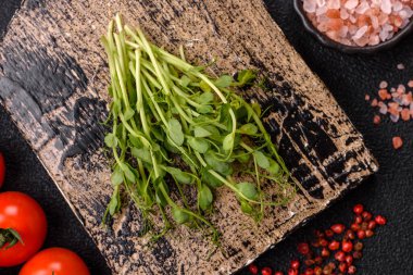 Sağlıklı bir detoks salatası ya da başka bir yemek için taze yeşil bezelye mikroyeşili filizleri. Tasarımınız için besin arkaplanı olarak bezelye mikroçimleri.