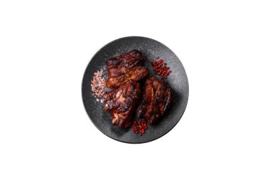 Grilled or barbecued pork ribs with sauce. Grilled ribs as a food background for your design.