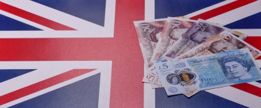 İngiltere kağıt parası, sterlin, finansal ve ticari işlemler için nakit para. Tasarımın için arka plan olarak Britanya parası