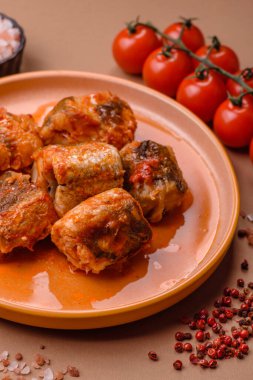 Domates sosunda haşlanmış balık, biberli güveç ve havuç. Tasarımınız için yemek arkaplanı olarak domates soslu haşlama balık..