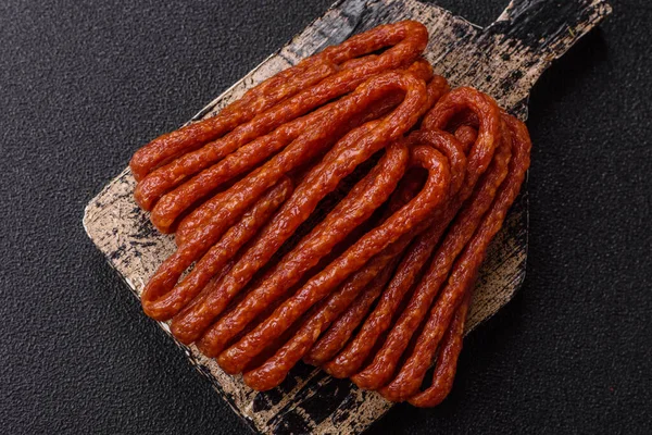 Tütsülenmiş kabinesi, ince salam sosisi, et çubukları veya aperatifler. Tasarımınız için gıda arka planı olarak Cabanossi sosisi.