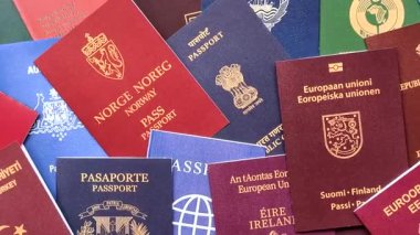 Farklı ülkelerin vatandaşlarının pasaportları, çeşitli ülkelerin pasaportlarından oluşan arka plan.